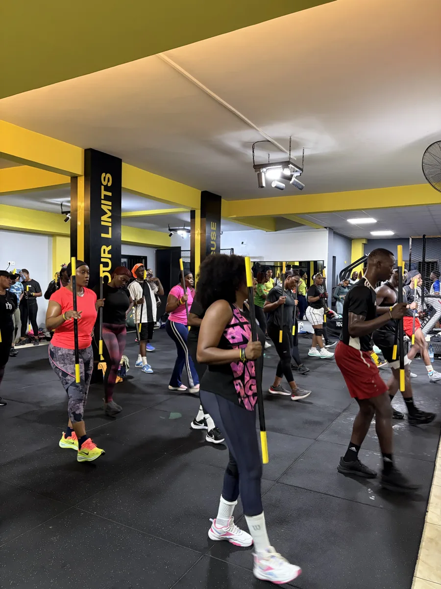 Rameur haut de gamme aux accents jaunes dans une salle sombre.